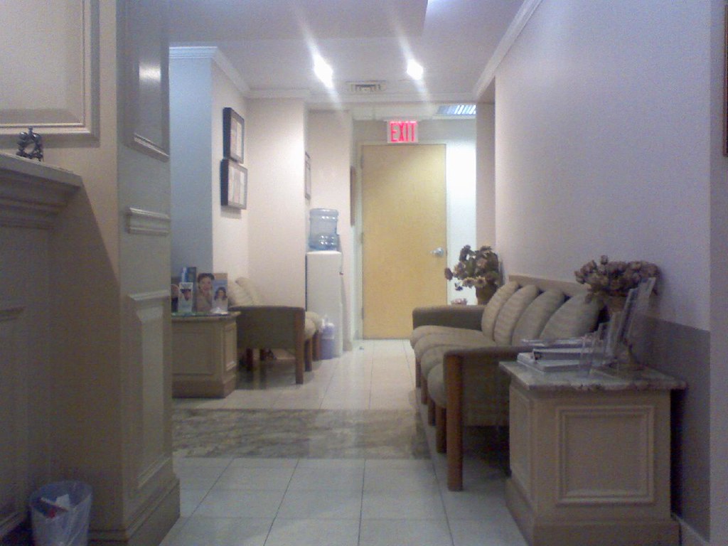 A patient holding a notebook with prepared questions while waiting in a doctor's office.